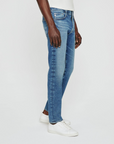 model facing sideways wearing ag jeans dylan slim fit jean in talavera blue, shown from the waist down