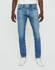 model facing forward wearing ag jeans dylan slim fit jean in talavera blue, shown from the waist down