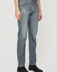 model wearing ag jeans tellis modern slim jean in 17 years gibson grey, shown from the waist down