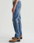model wearing ag jeans tells modern slim jean in 16 years clifton blue, shown from the side