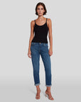 model wearing 7 for all mankind josefina boyfriend fit jean in broken twill vanity blue, paired with a black tank top and sandals