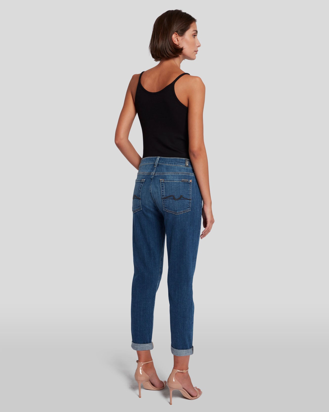 model wearing 7 for all mankind josefina boyfriend fit jean in broken twill vanity blue, facing away showing rear of the jeans