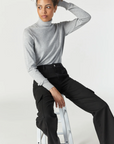 model seated, wearing mavi jeans alva cargo pant in black luxe twill