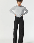 model wearing mavi jeans alva cargo pant in black luxe twill, with grey shirt and black shoes