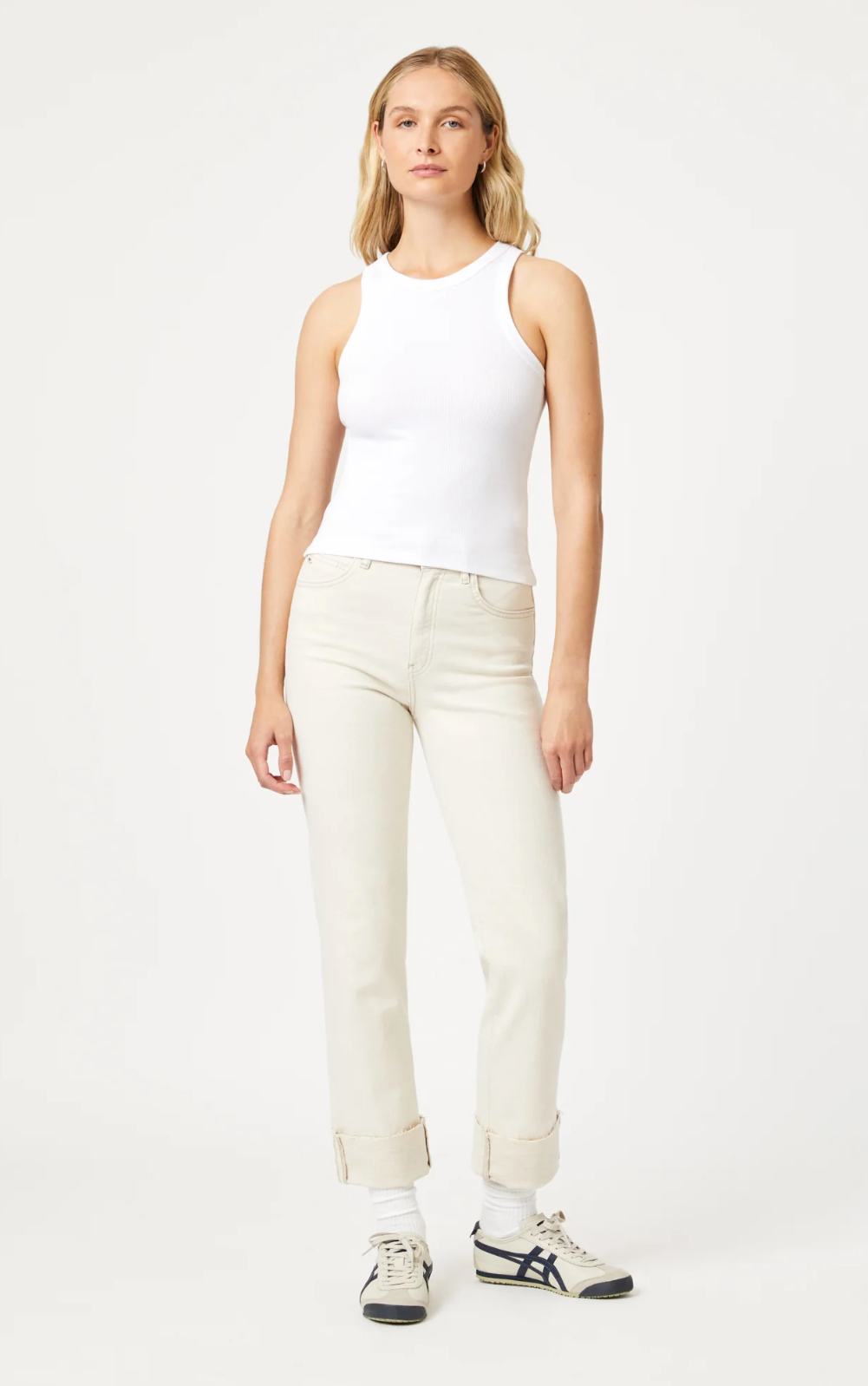 model wearing the white jersey tank from mavi jeans, paired with beige pants and sneakers