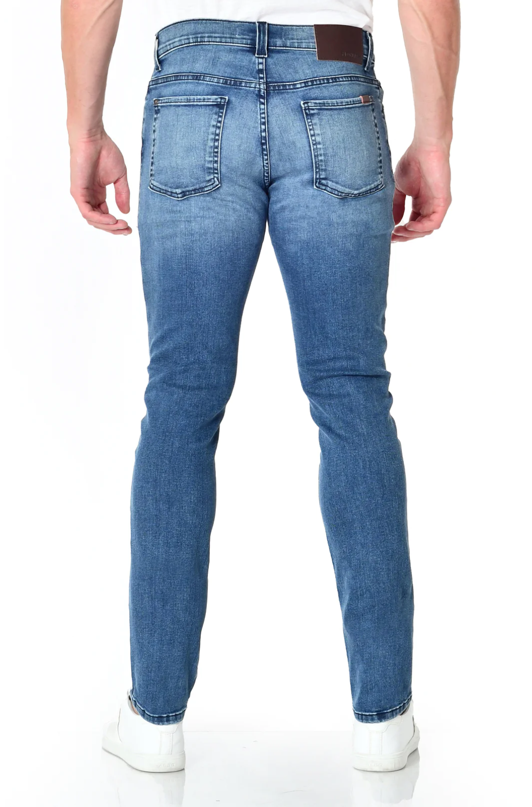 model wearing fidelity denim torino slim fit jean in tower blue, shown from the rear