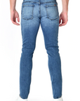 model wearing fidelity denim torino slim fit jean in tower blue, shown from the rear