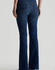 model facing away wearing ag jeans farrah boot cut in kindling blue, shown from the rear