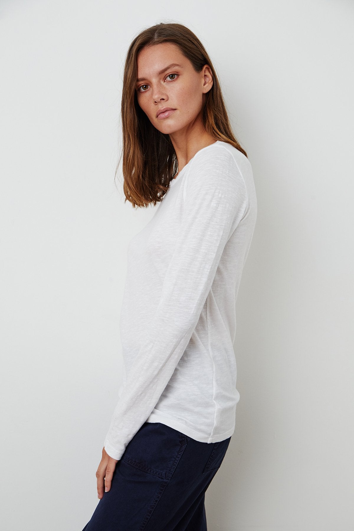 model wearing liz city slub crew neck long sleeve tee in white from Velvet, standing sideways