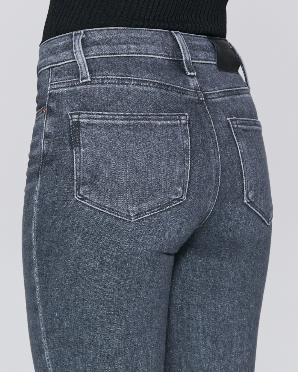 close up rear view of the cindy jean with raw hem from paige in grey, showing rear pocket detail