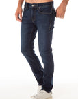 model wearing fidelity denim jimmy slim straight jean in empirical blue, shown from the side