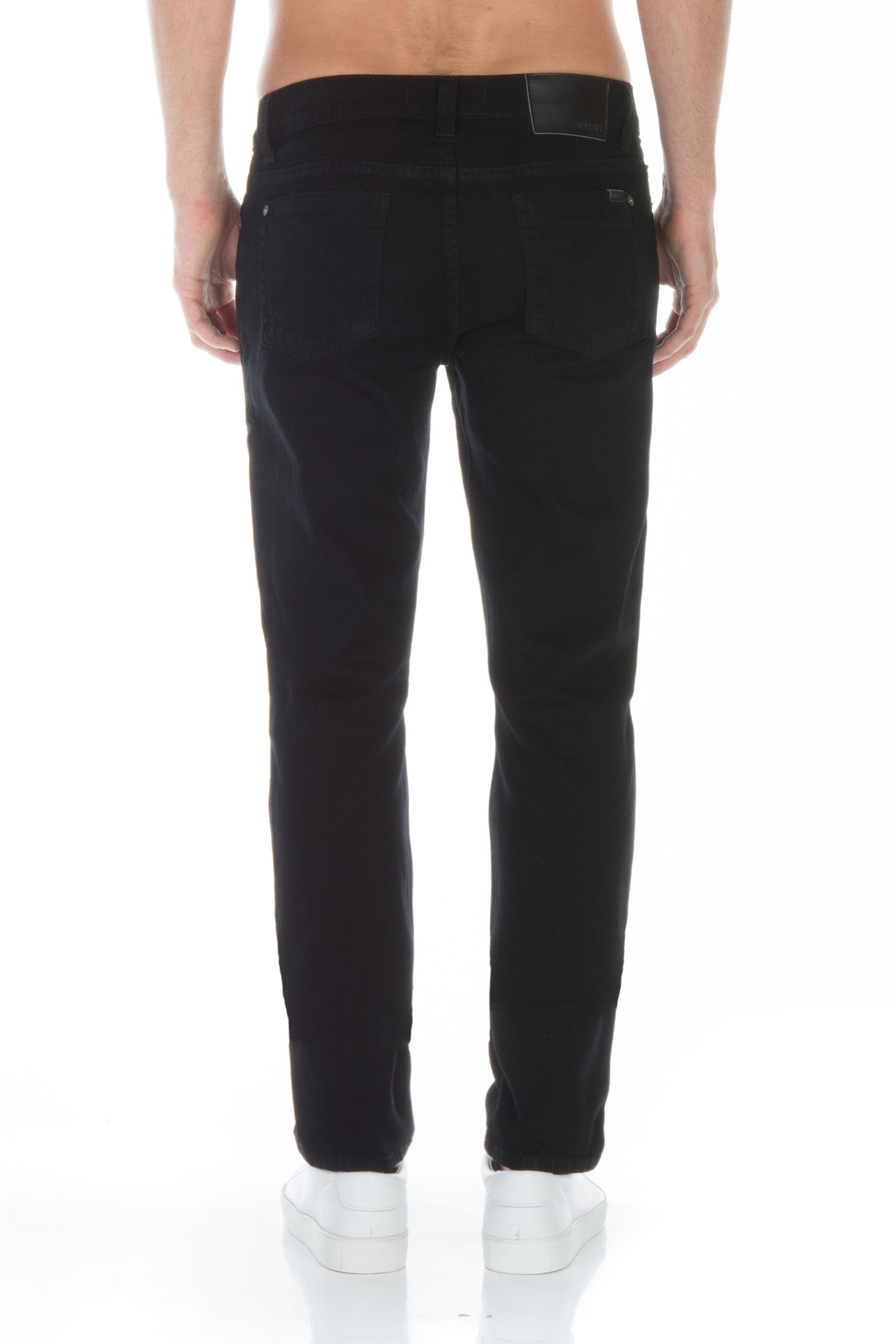 model wearing fidelity denim torino slim fit jean in gotham black, shown from the rear