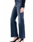 model wearing fidelity denim katie trouser fit in st tropez blue, shown from the side