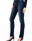 model wearing fidelity denim stevie mid rise slim jean in richmond blue, shown from the side