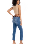 model wearing fidelity denim cher slim jean in st martin blue, shown from the rear and paired with beige tank top