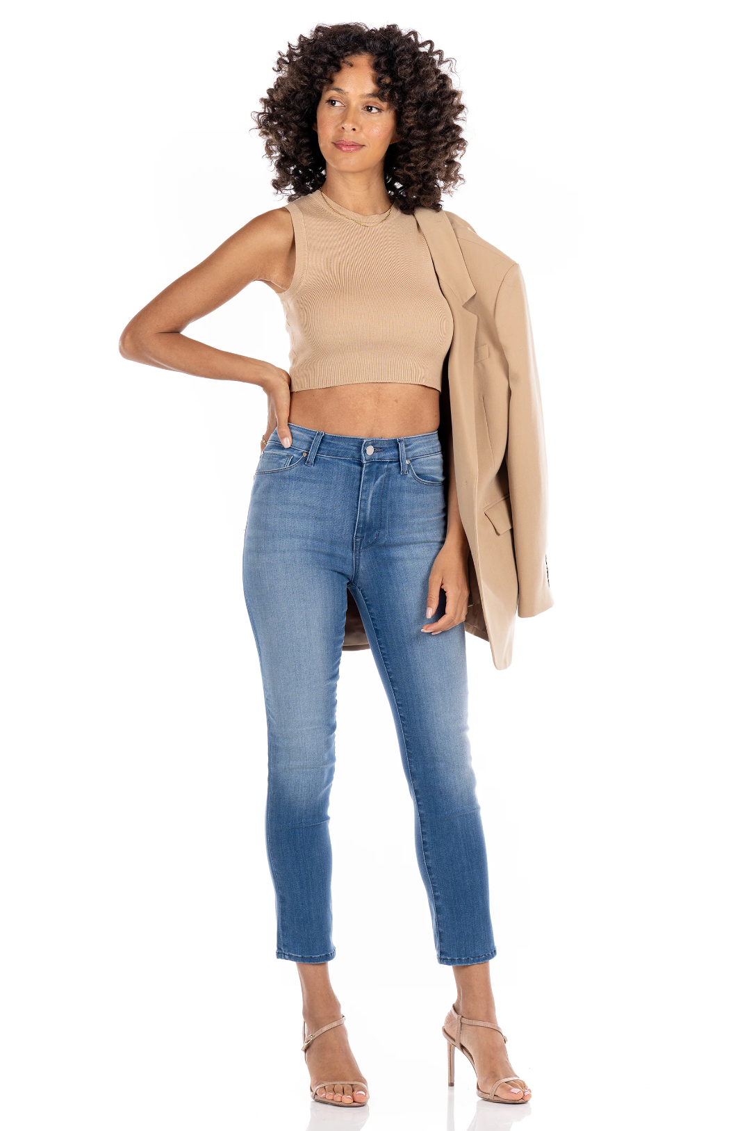 model wearing fidelity denim cher slim jean in st martin blue, paired with beige tank and blazer