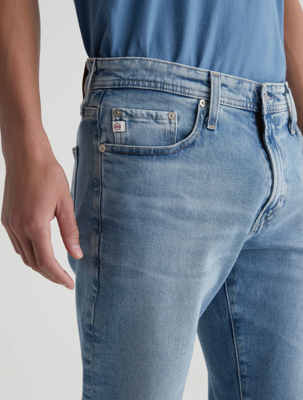 close up of the front of the ag jeans kora high rise wide leg jean in recall blue, showing front pockets