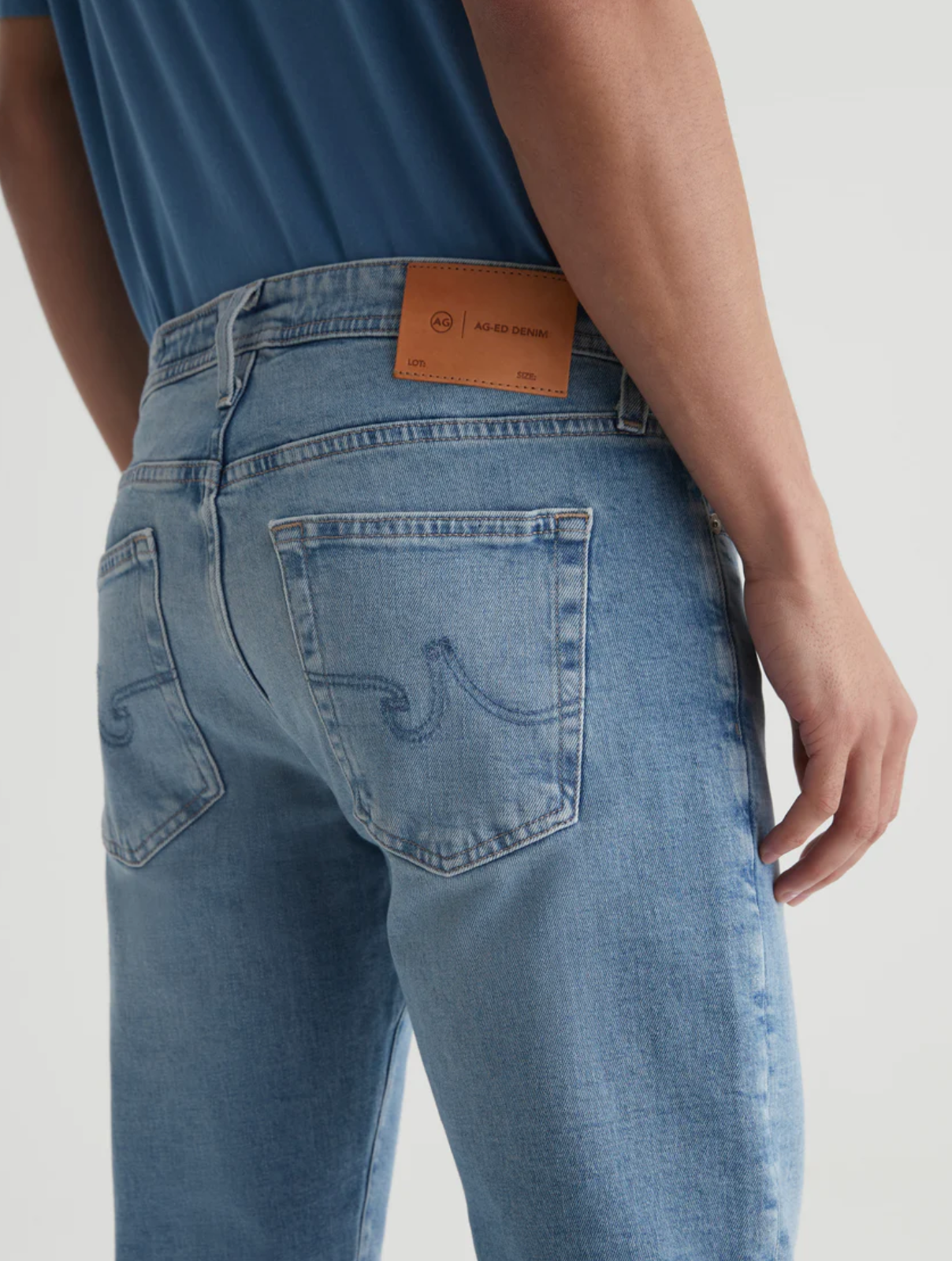 close up of the rear of the ag jeans kora high rise wide leg jean in recall blue, showing detail on back pockets