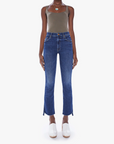 front view of the insider crop step fray jean from Mother in teaming up blue, styled with an olive green tank top and white clogs