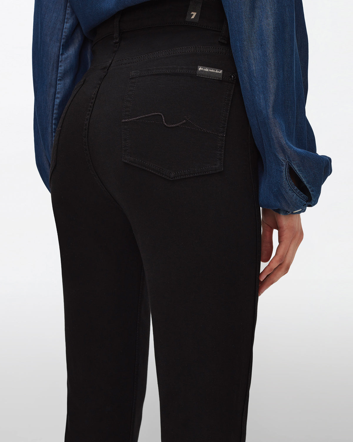 close up rear pocket view of 7 for all mankind&#39;s high waist slim kick jean in black 