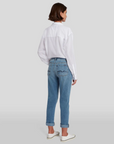 model wearing 7 for all mankind josefina boyfriend fit jean in bright light broken twill blue, shown from the rear