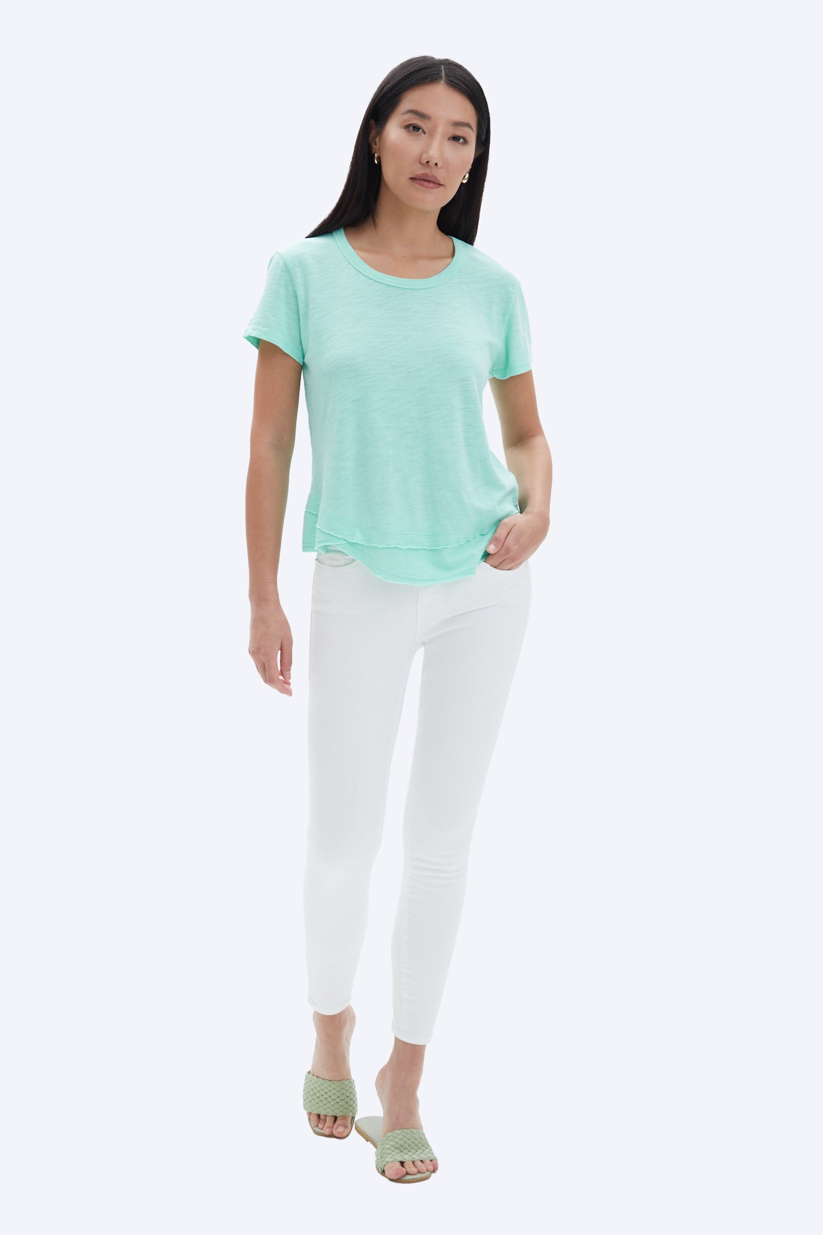 model wearing chrldr ava mock layer t shirt in light green, with white pants