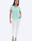 model wearing chrldr ava mock layer t shirt in light green, with white pants