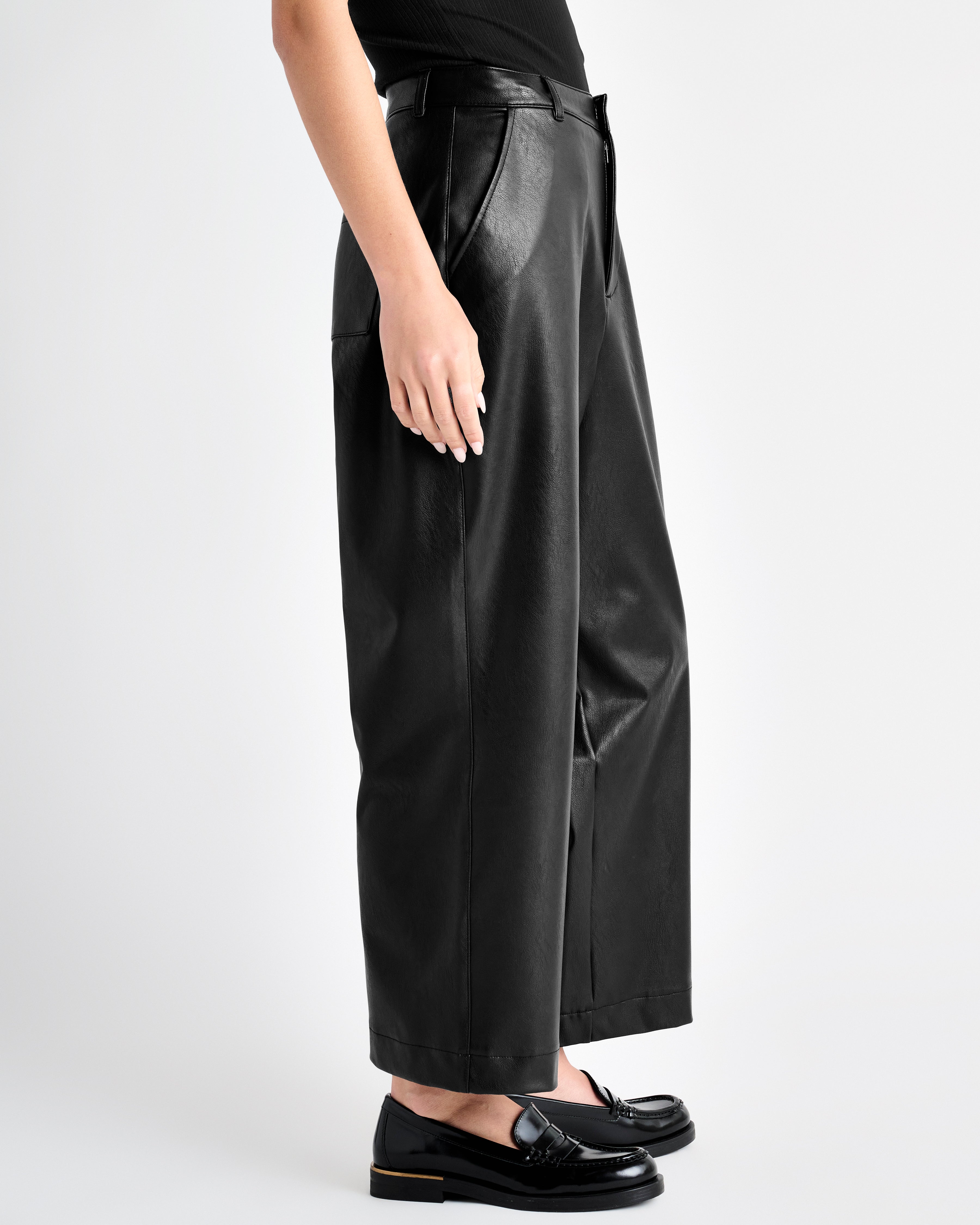 side view of the black vegan leather ankle length wide leg trousers