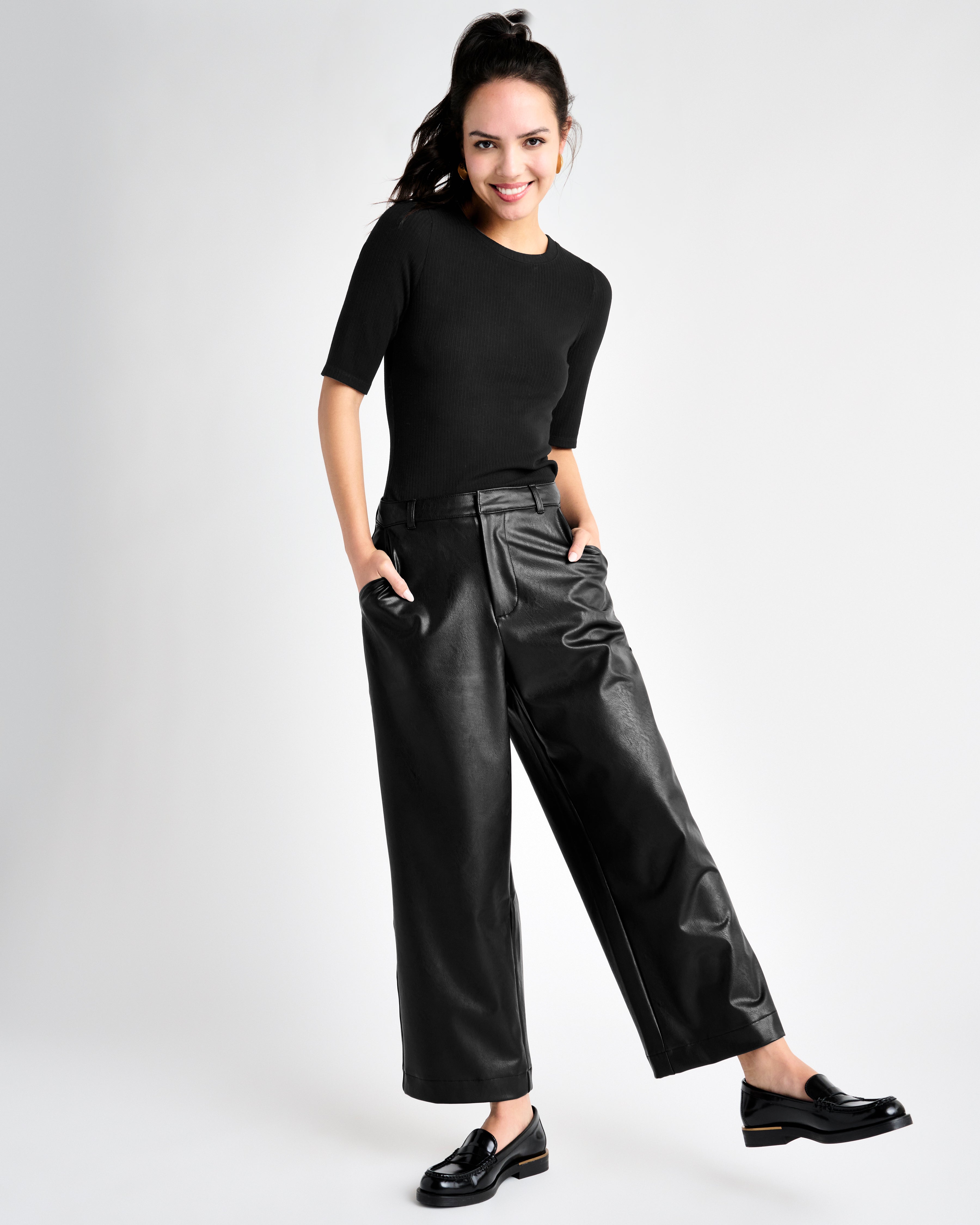 black vegan leather ankle length wide leg trousers styled with a black shirt