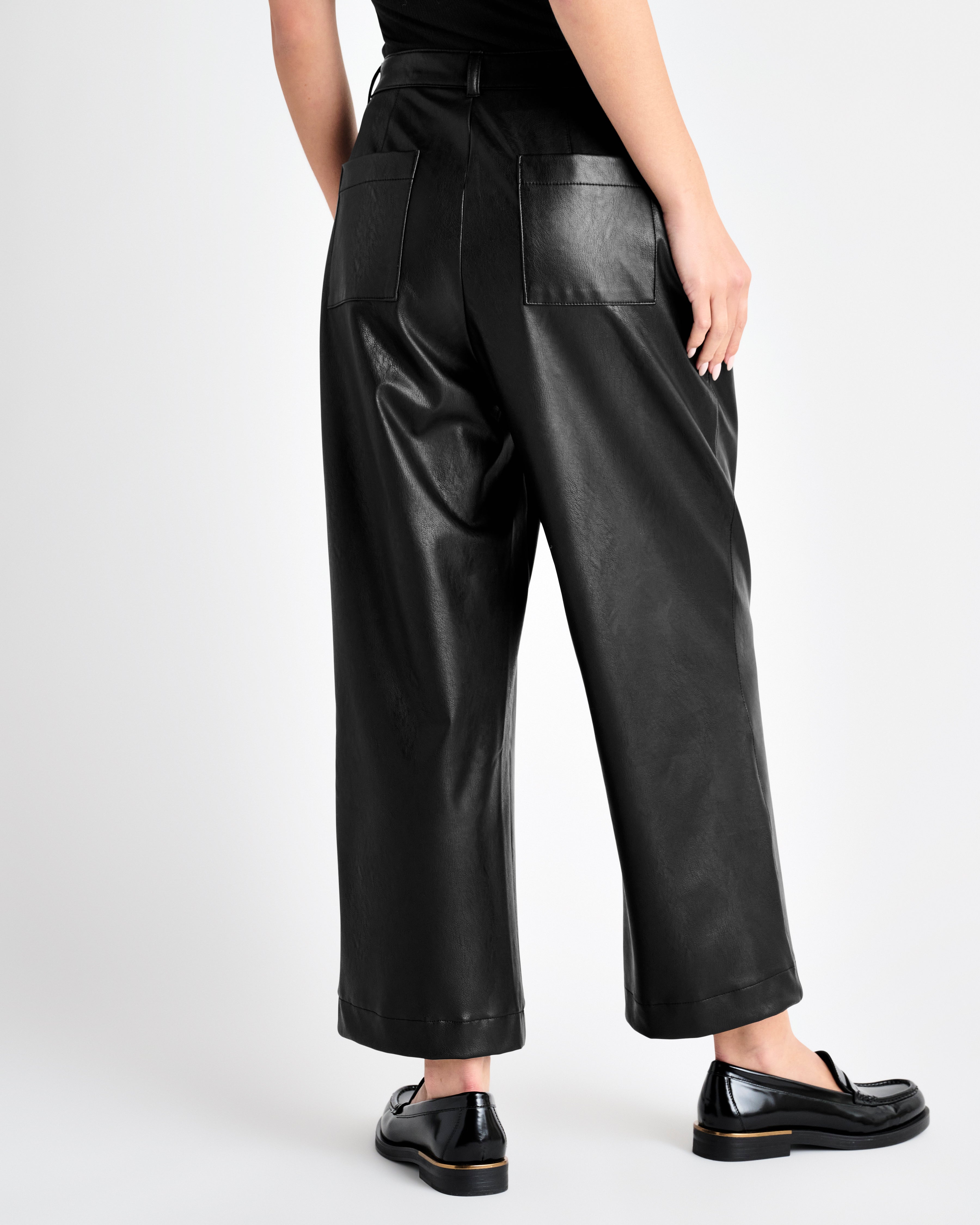 rear view of the black vegan leather ankle length wide leg trousers