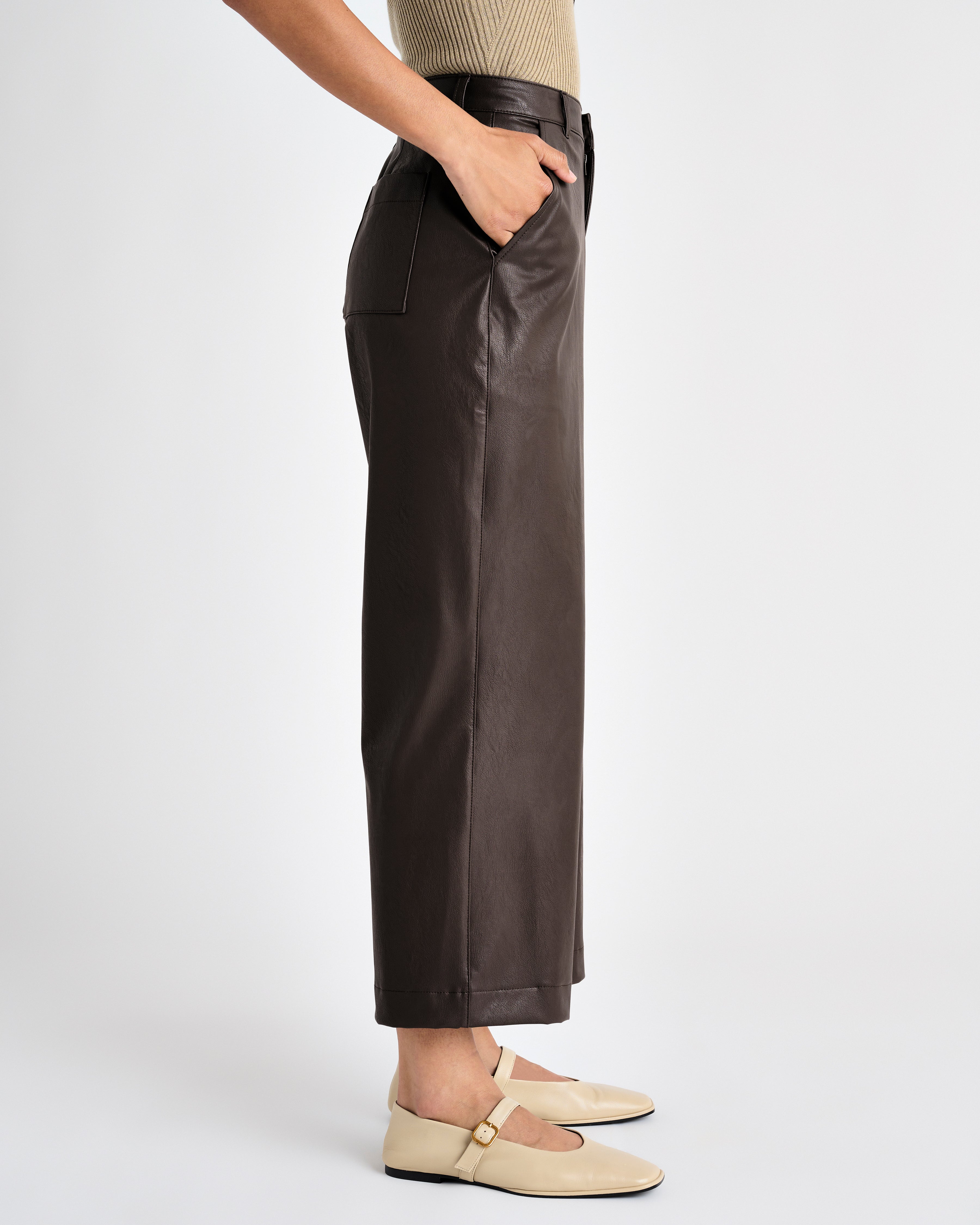 side view of the dark brown vegan leather ankle length wide leg trousers