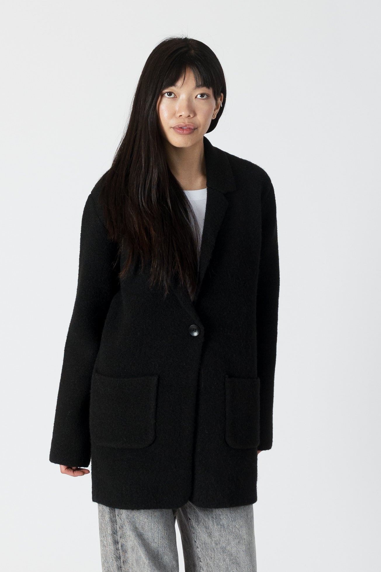 model wearing genie knit boyfriend blazer in black, front view