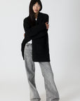 model wearing genie knit boyfriend blazer in black, posed