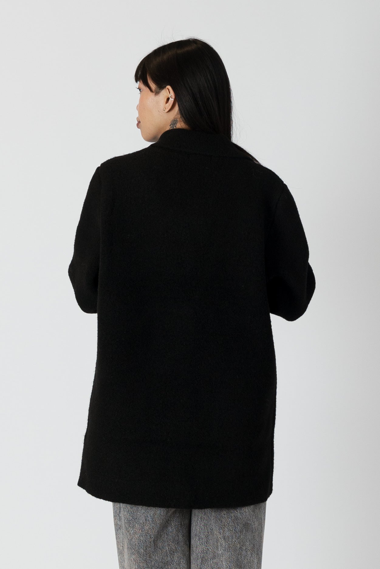 model wearing genie knit boyfriend blazer in black, rear view