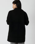 model wearing genie knit boyfriend blazer in black, rear view