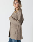 model wearing genie knit boyfriend blazer in beige, side view