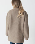 model wearing genie knit boyfriend blazer in beige, rear view