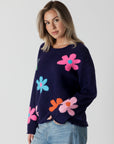 model wearing lyla & luxe jodi multicolour flower print sweater, angled view