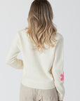 model wearing jolene button front floral print cardi from lyla & luxe, rear view 