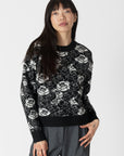 model wearing jordyn rose print crew neck sweater from lyla & luxe, front view