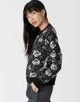 model wearing jordyn rose print crew neck sweater from lyla & luxe, side view