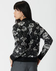 model wearing jordyn rose print crew neck sweater from lyla & luxe, rear view