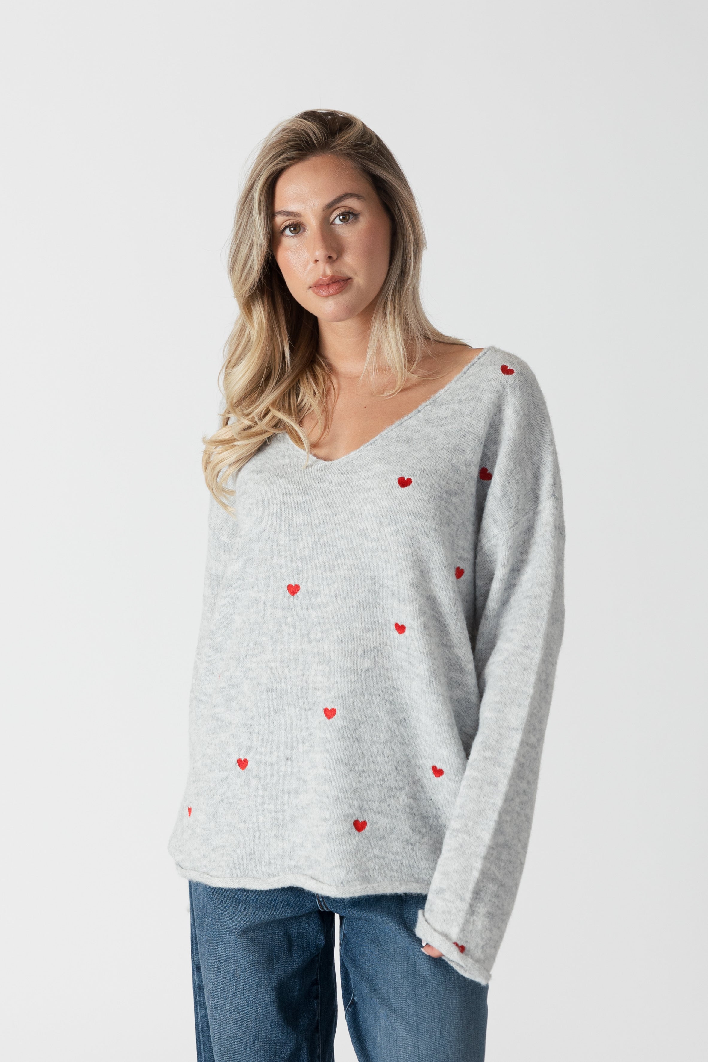 model wearing lyla &amp; luxe luna v-neck embroidered hearts sweater, front view