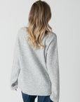 model wearing lyla & luxe luna v-neck embroidered hearts sweater,  rear view