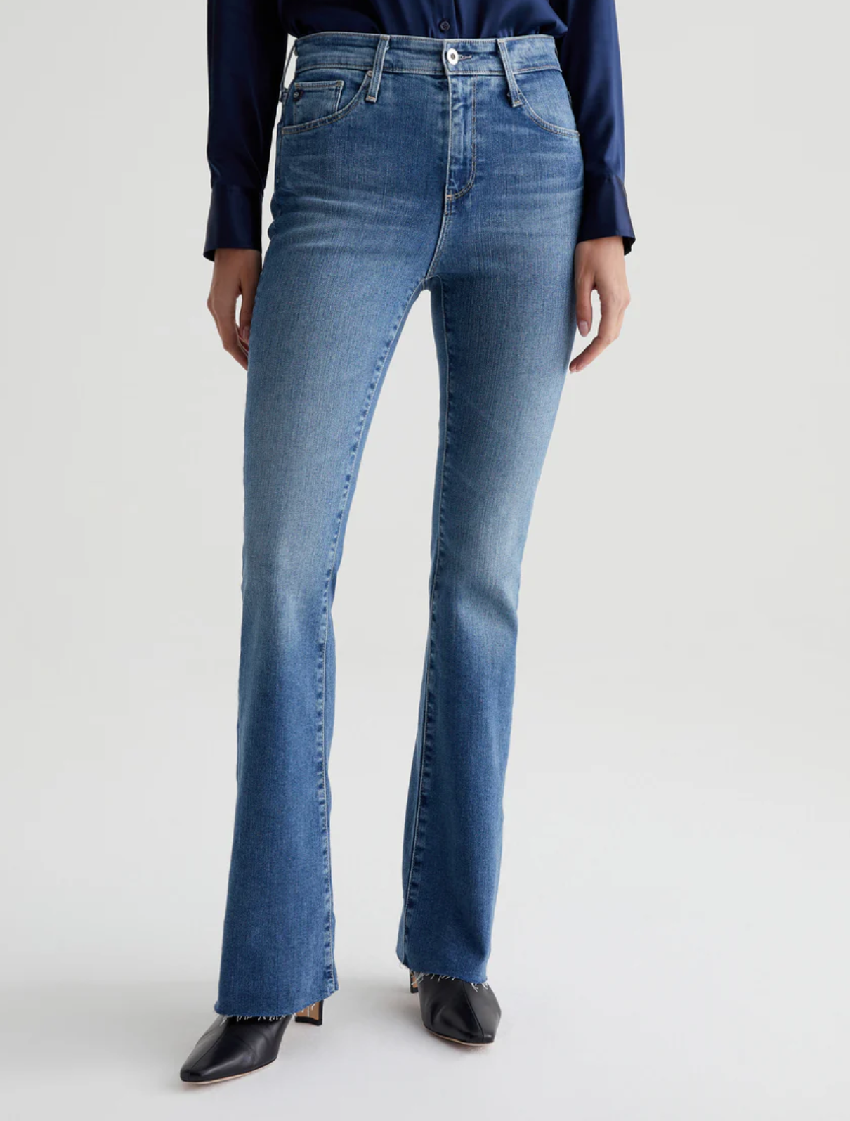 model wearing ag jeans farrah boot cut jean in montecito blue, shown from the waist down