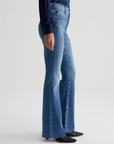 model wearing ag jeans farrah boot cut jean in montecito blue, shown from the side