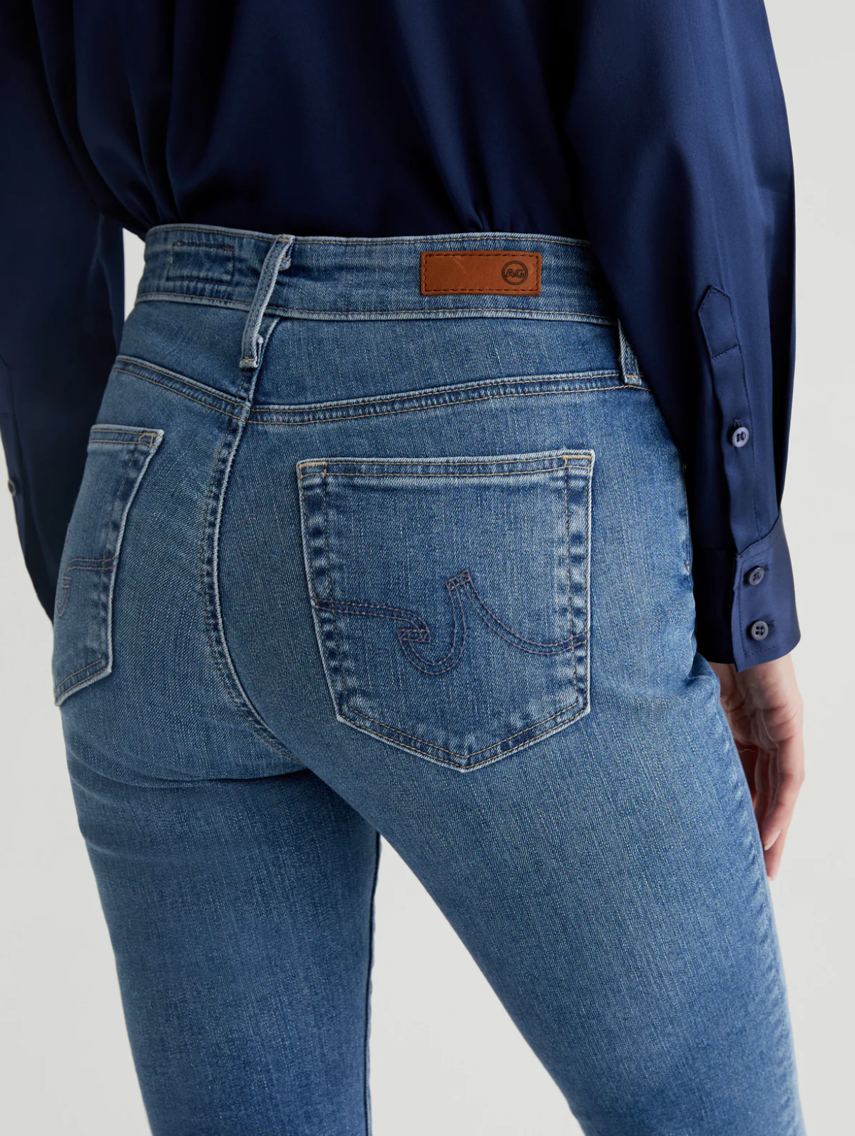 close up of the rear of ag jeans farrah boot cut jean in montecito blue, showing back pocket detail