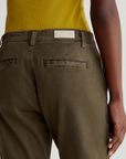 close up of rear ag jeans caden tailored trouser in sulfur shady moss green, showing back pocket