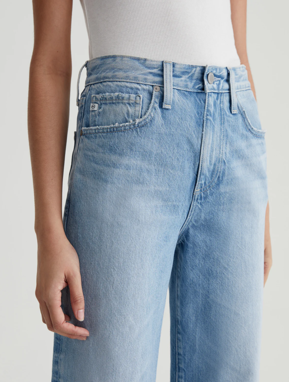 close up of the front of the ag jeans kora high rise wide leg jean in recall blue, showing front pockets