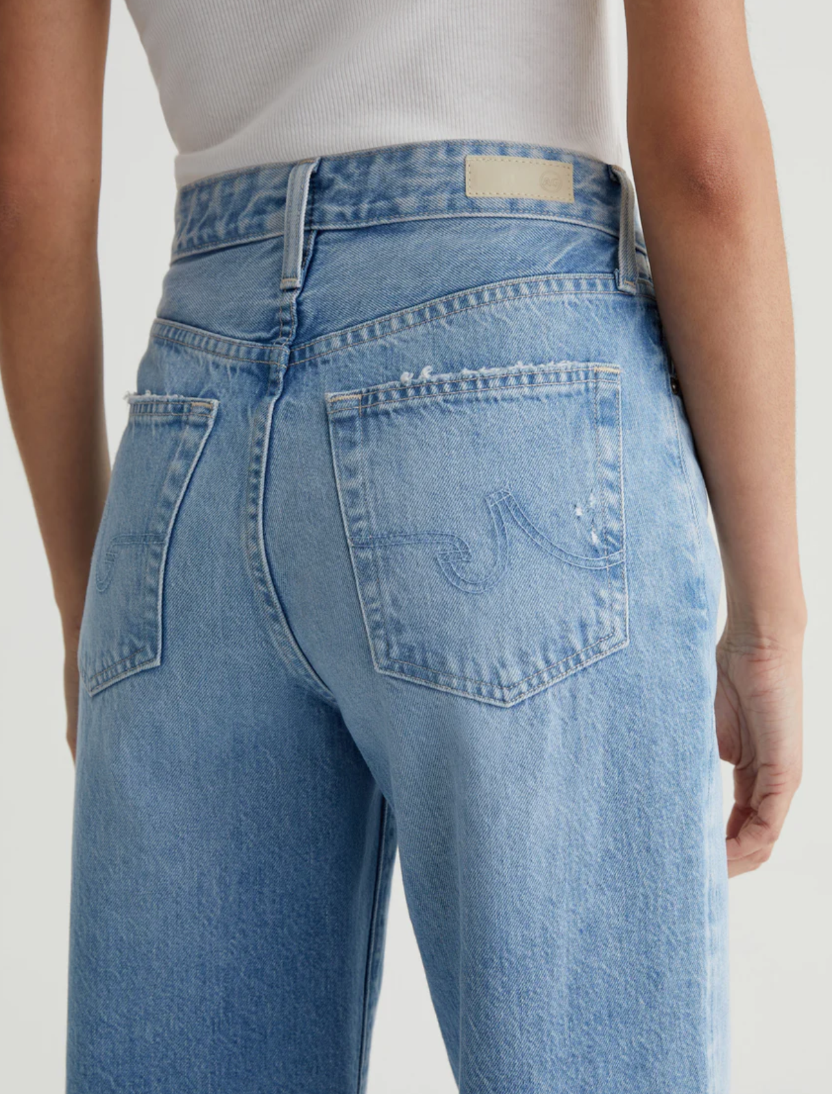 close up of the rear of the ag jeans kora high rise wide leg jean in recall blue, showing back pocket detail 